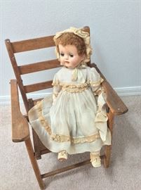 Antique doll and children's chair.