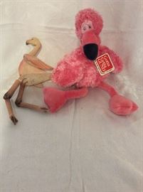 Flamingo plush and wooden figure. 
