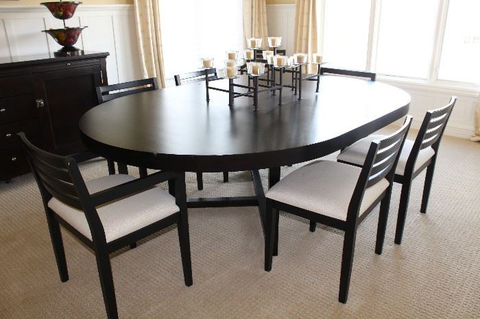 With two extensions; table is 7 feet long and is 5 feet wide. Each extension is 15" long. 