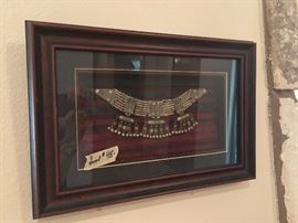 tribal framed necklace history on back