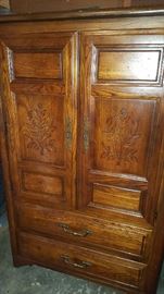 armoire which is part of a matching bedroom set including a headboard, dresser with mirror, and 2 night stands