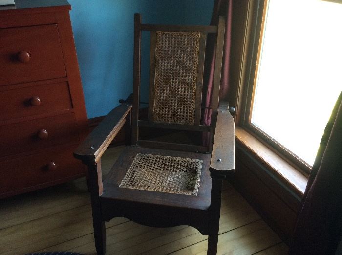 Unique Morris Plantation chair with arm extensions. Legs were rested up on those extensions for relaxation. Oak, seat needs caning. 