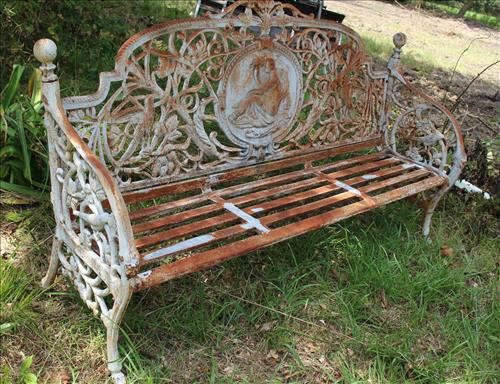 69 - Large heavy matched pair of solid cast iron garden benches, crest of lady, 41 in. T, 72 in. W, 15 in