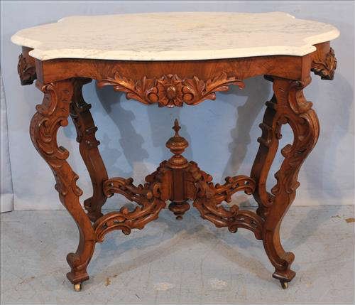 82 - Walnut Victorian marble top center table with turtle top, 30 in. T, 38 in. W, 21 in. D.