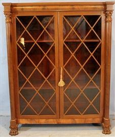 119 - Mahogany Empire 2 door bookcase with column front and claw feet, 61 in. T, 49 in. W, 16 in. D.