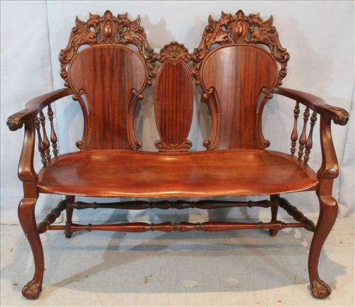 127 - Stickley mahogany loveseat with carved crown, ball and claw feet, 40 in. T, 46 in. W, 19 in. D.