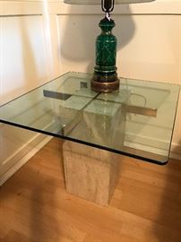 One of a pair of matching marble and glass tables