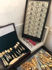 Gold washed flatware with an official sheet of Treasury one dollar bills