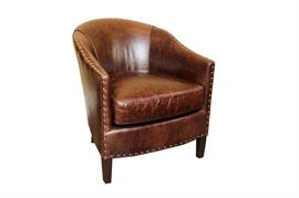 Arhaus "Giles" Leather Club Chair: A Giles leather footed club chair by Arhaus. The chair is in a rich, molasses color with a natural distressed finish. Nailhead detailing borders the base, arms, and curved back. Matches another chair being sold separately in the sale as item 17CIN250-028.
