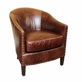 Arhaus "Giles" Leather Club Chair: A Giles leather footed club chair by Arhaus. The chair is in a rich, molasses color with a natural distressed finish. Nailhead detailing borders the base, arms, and curved back. Matches another chair being sold separately in the sale as item 17CIN250-048.