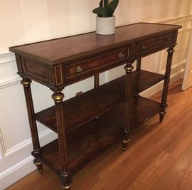Theodore Alexander Regency style flame mahogany veneer and solid mahogany three tier console table. Turned peg feet.  