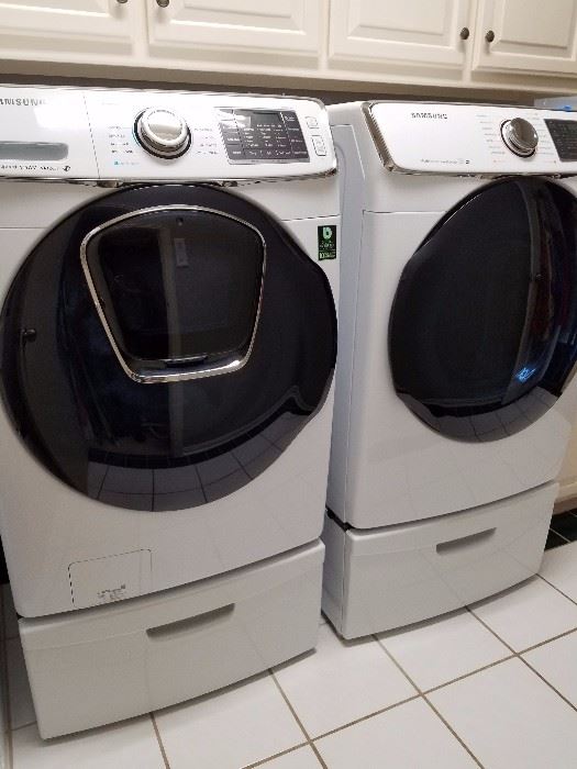 SAMSUNF ENERGY EFFICIENT 
WASHER AND DRYER AND STANDS.PURCHASED IN 2016