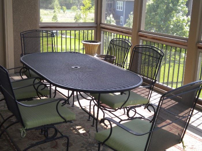 Oval wrought iron patio set table and 6 coil spring chairs