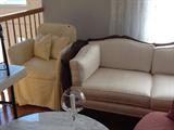 White silk caned sofa and small custom yellow chair. Great for a little girl's room