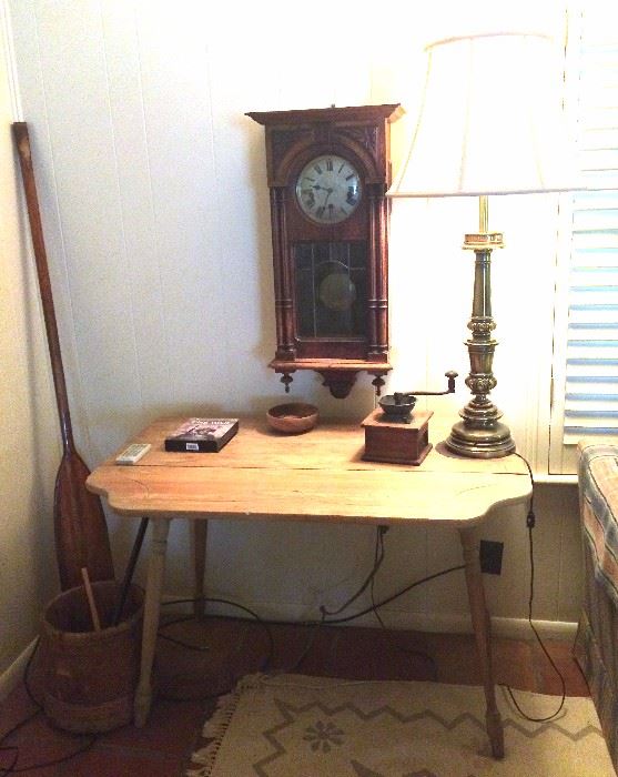 Drop leaf table, lamp, antique coffee grinder, antique wall clock, butter churn bucket, oar