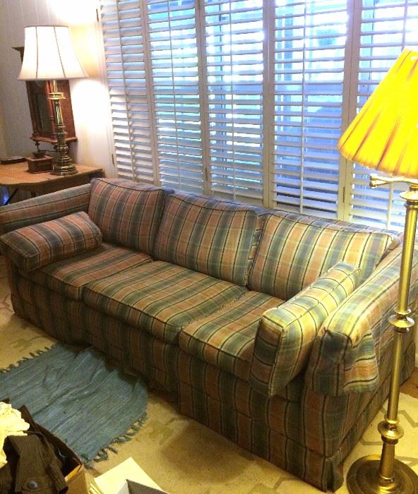 Plaid sofa, brass floor lamp