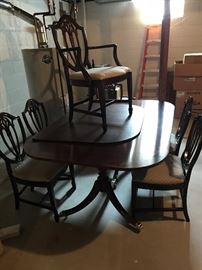 Super clean mahogany inlaid table with two large leaves and 6 clean sturdy chairs