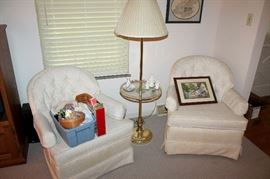 Upholstered armchairs and brass lamp table