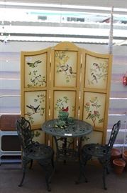 Patio full of garden decor, table and chairs, folding screen and more