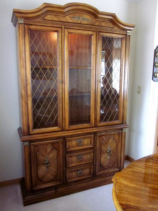 High quality (Stanley Furniture), solid wood china cabinet with glass shelves, lighted, brass lattice inserts and hardware, lots of bottom storage.  52" wide, 83" tall, 15-1/2" deep.