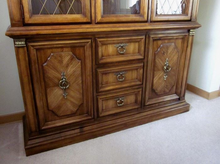 High quality (Stanley Furniture), solid wood china cabinet with glass shelves, lighted, brass lattice inserts and hardware, lots of bottom storage.  52" wide, 83" tall, 15-1/2" deep.