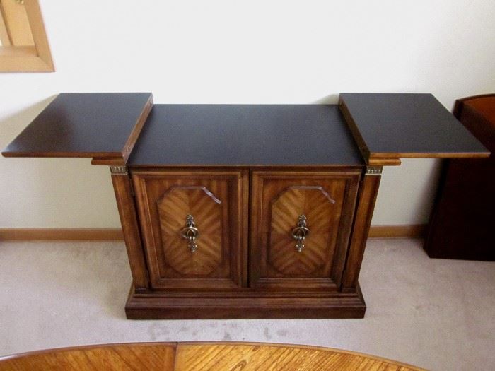 High quality (Stanley Furniture), solid wood buffet server.  Top flips open for additional serving space.  One drawer, storage behind double doors.  37" wide, 19" deep, 30" tall.  Top opens to 59".