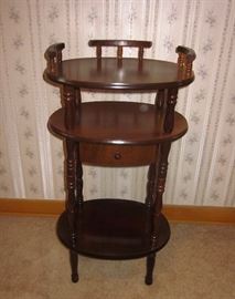 Oval side table, 3 shelves, 1 drawer, spindle legs, 30" tall.