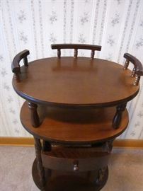 Oval side table, 3 shelves, 1 drawer, spindle legs, 30" tall.