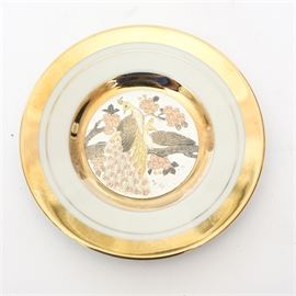 Japanese Chokin Collectible Plate: A Japanese Chokin art collectible plate made in Japan. The plate is painted with a gold and bronze engraving of a peacock. The plate is rimmed in 24K gold. This plate is number 1061 out of a limited edition of 9500.