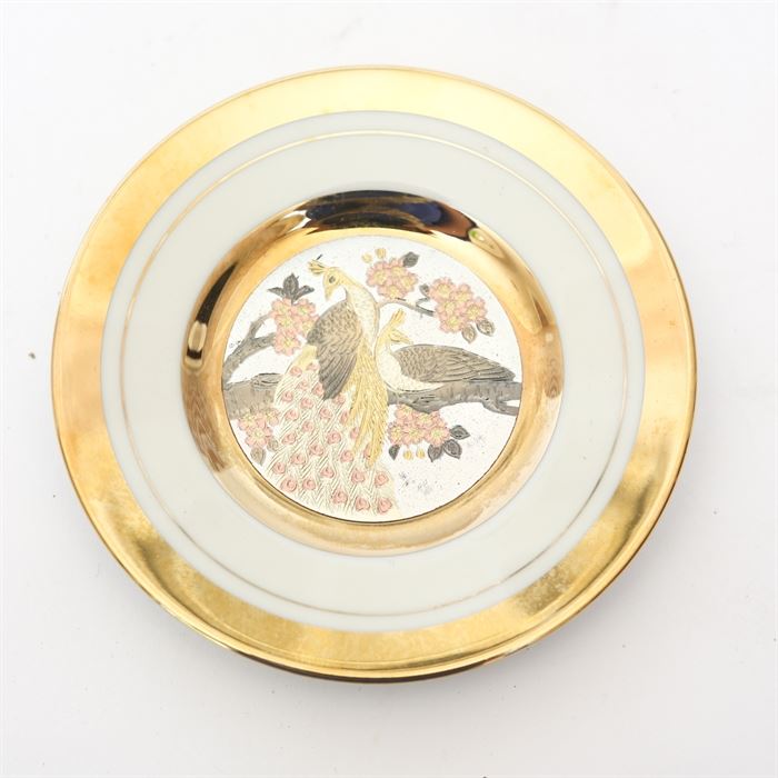 Japanese Chokin Collectible Plate: A Japanese Chokin art collectible plate made in Japan. The plate is painted with a gold and bronze engraving of a peacock. The plate is rimmed in 24K gold. This plate is number 1061 out of a limited edition of 9500.