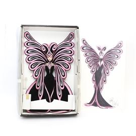 Bob Mackie Limited Edition Le Papillon Barbie 1999: A Bob Mackie Le Papillion Barbie by Mattel dated 1999. The Barbie is new in the box and comes with the Bob Mackie signed dress desgn. The Barbie is clothed in an original Bob Mackie design of a pink and black butterfly dress with wings and a head piece.