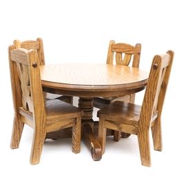 Solid Oak Table and Chairs for Dolls: A solid oak table and chair set for dolls or children. The table is round in a farmhouse style wth four cross backed chairs. The set is hand made from solid oak.