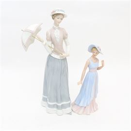 Two HOMCO Figurines "Lady Catherine" and "Camille": A pair of two HOMCO porcelain figurines; Lady Catherine and Camille. Lady Catherine # 14019 released in 2001 is dressed in a pink blouse with a blue skirt and coordianting parasol. She is made of bisque porcelain and in 13" tall. Camille #14039 was realeased in 2003. Camille is dressed in a flowing lavender dress and matching hat. She is wearing a strand of pearls.
