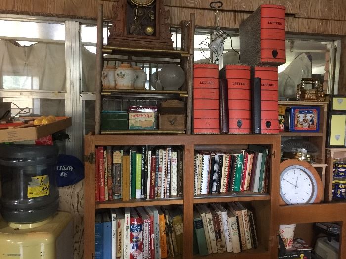 Water cooler. Cookbooks, clock, old ledger/document boxes, 50s yellow and chrome canisters. 
