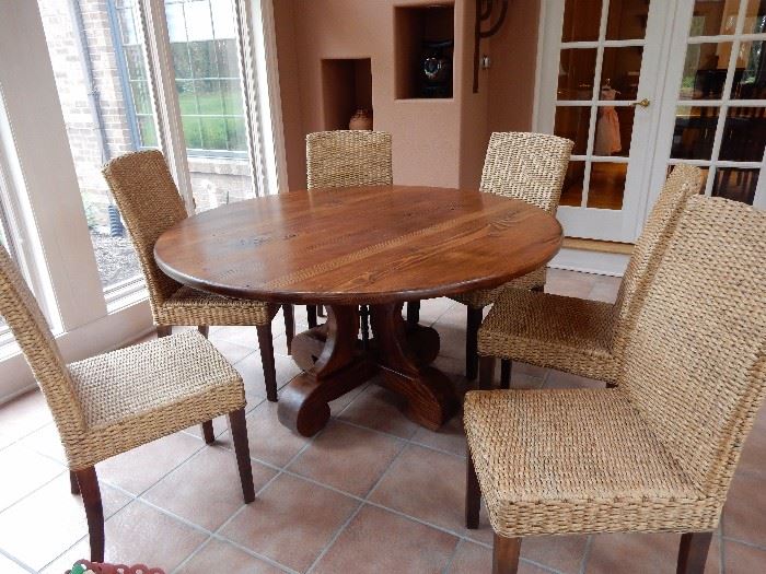 Natural Wood Pedestal Table with 6 glorious rattan and wood chairs. by  Mig and Tig
