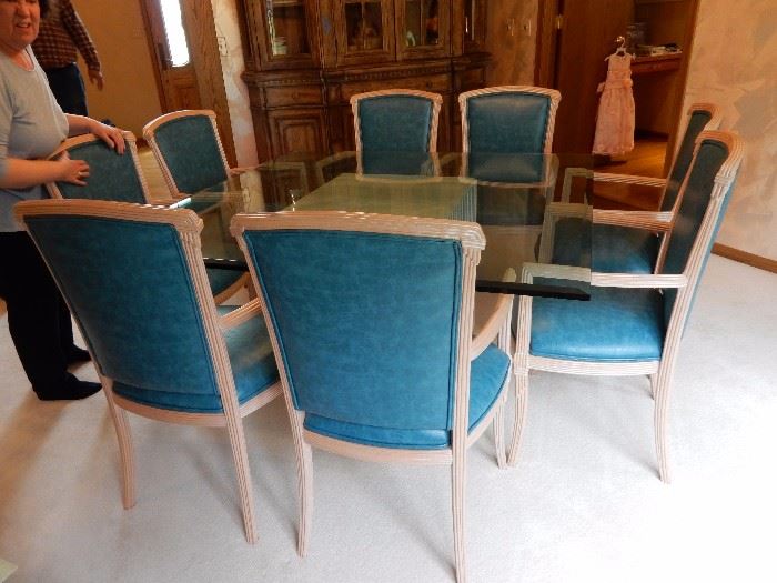 glass dining suite with 8 teal leather chairs 