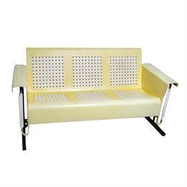 Vintage Patio Glider: A vintage painted metal patio glider. The glider is made of yellow and white painted metal, featuring curved metal armrests, and a basket-weave texture to the seat and back. The seat is attached to a steel frame that allows it to rock. No maker’s marks.