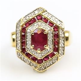 14K Yellow Gold, Ruby, and Diamond Hexagonal Cocktail Ring: A 14K yellow gold hexagonal cocktail ring featuring one center oval cut ruby framed by alternating layers of diamonds and smaller channel set rubies.