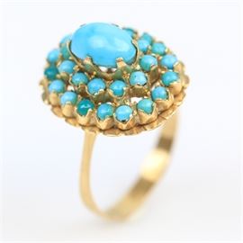 18K Yellow Gold and Turquoise Cocktail Ring: An 18K yellow gold cocktail ring featuring one center turquoise oval cabochon framed by two rows of round turquoise cabochons.