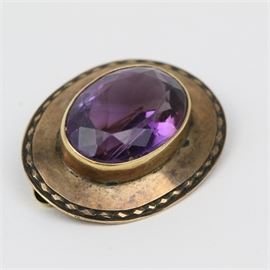 Victorian 14K Rose Gold and 9.00 CTS Amethyst Brooch: A Victorian 14K rose gold brooch with one center faceted oval brooch and a c-clasp closure.