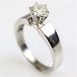 Marinelli 14K White Gold and Diamond Cathedral Solitaire Engagement Ring: A Marinelli 14K white gold solitaire ring featuring one center prong set round brilliant cut diamond mounted atop a cathedral style shank.