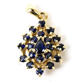 14K Yellow Gold and Sapphire Cluster Pendant: A 14K yellow gold teardrop pendant featuring a cluster of faceted round and pear cut sapphires with a tapered bail.