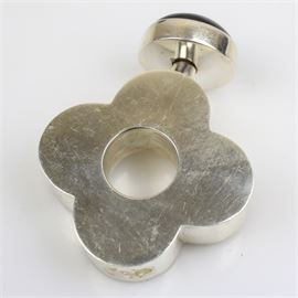 Sterling Silver and Onyx Perfume Bottle: A sterling silver and onyx perfume bottle. The bottle features a quatrefoil/ flower-shaped body with a circle cut out to the center and an off-center screw off lid accented by one bezel set 1.10″ × 1.10″ onyx round cabochon. The piece is marked “925” with a total approximate weight of 1.99 ozt.