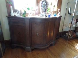 Baker Furniture curved front sideboard with drawers in the center.