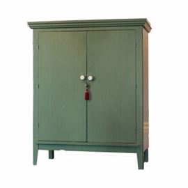 Vintage Painted Green-Wood Cabinet: A vintage painted green wood cabinet. The vintage piece has a molded cornice above double hinged doors with white pulls that opens to reveal an interior fitted with chrome-finished coat hangers. The whole resting on splayed legs.