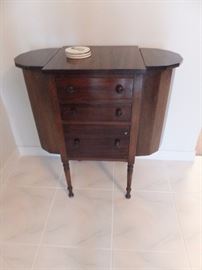 Antique sewing table with side wells that open from the top