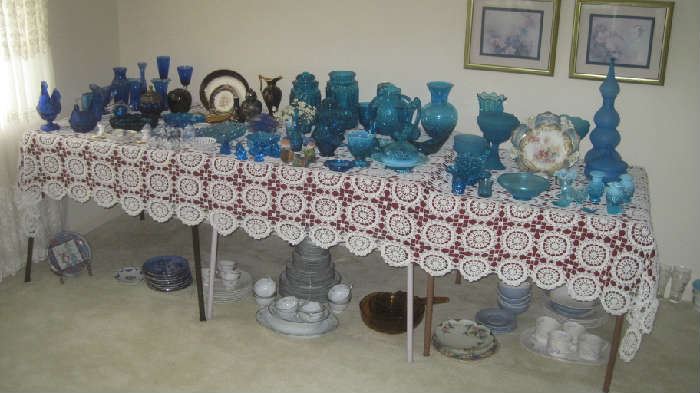 Large display of colored blue glass, Noritake Colburn china on floor 