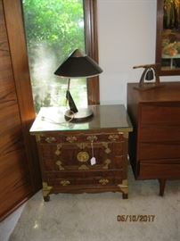 Asian bedside table, one of two, shown with a Panasonic table lamp