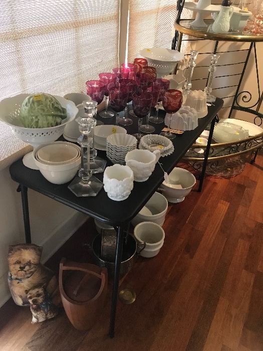 A table full of white milk glass, white porcelain. Red cut to clear stemware and more.