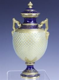 
Crafted of fine quality English porcelain. Features highly sought after enameled jewel decoration in turquoise against a gold body. Double handled design with cobalt blue bands. Signed with Coalport England backstamp. Measures 7" x 3 1/2" Very good condition with no chips, cracks, breaks or repairs. Light wear to gold trim. In house USA continental shipping $45 plus insurance